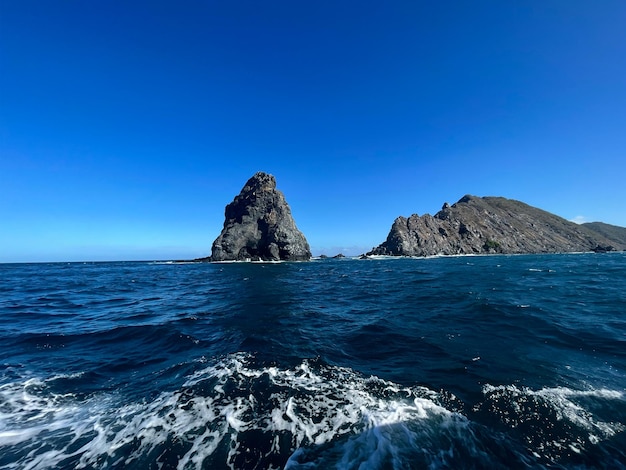 View from the sea, of the cliff in Bahía de La Cruz, Guanacaste, Costa Rica, on a sunny day.