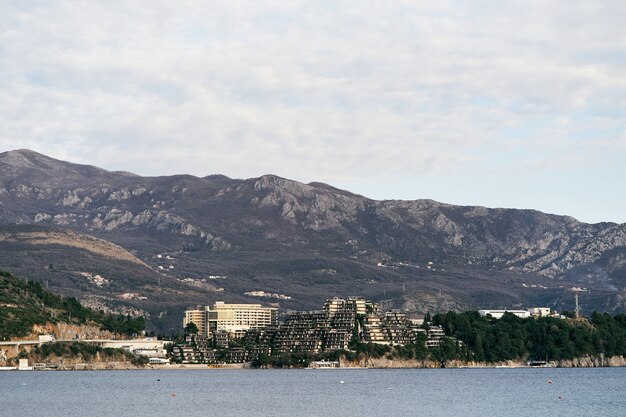 View from the sea to the coast with houses and green trees around