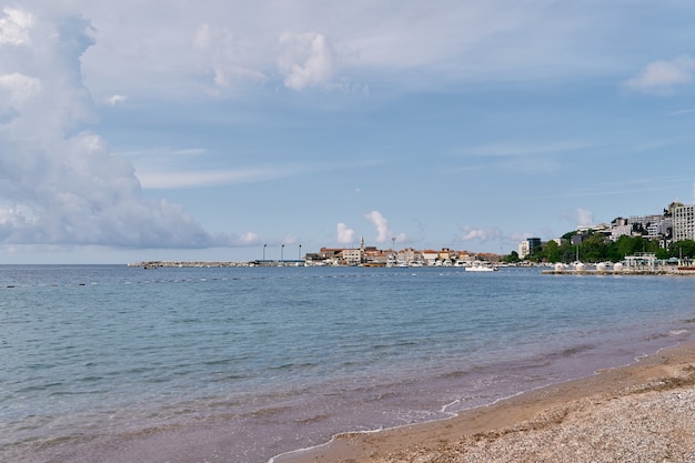 View from the sea to the peninsula with houses surrounded by green trees