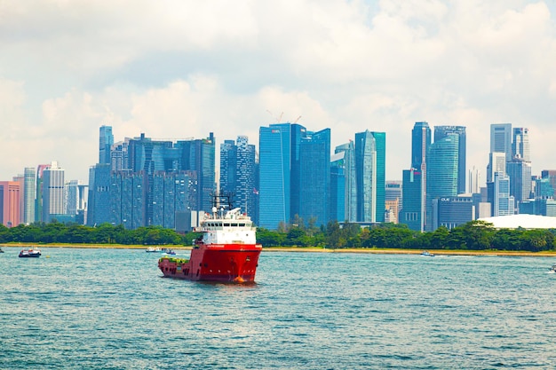 View from the sea to Singapore with highrise buildings and the coast and transport ships at anchor