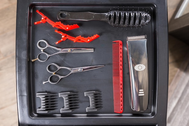 View from above on set of professional hairdresser tools on a special stand in beauty salon