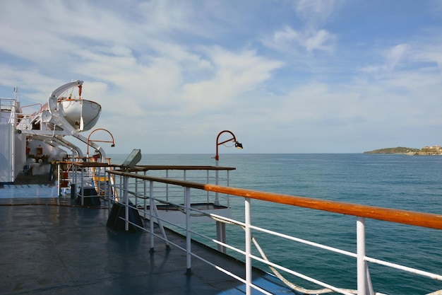 A view from the side of a large seagoing ship on a picturesque coast and landscape
