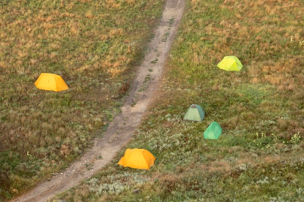 View from the top and camping with tourist tents against the backdrop of nature. High quality photo