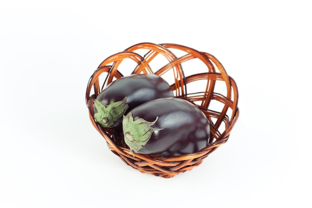 View from the toptwo ripe eggplant in a wicker basketisolated