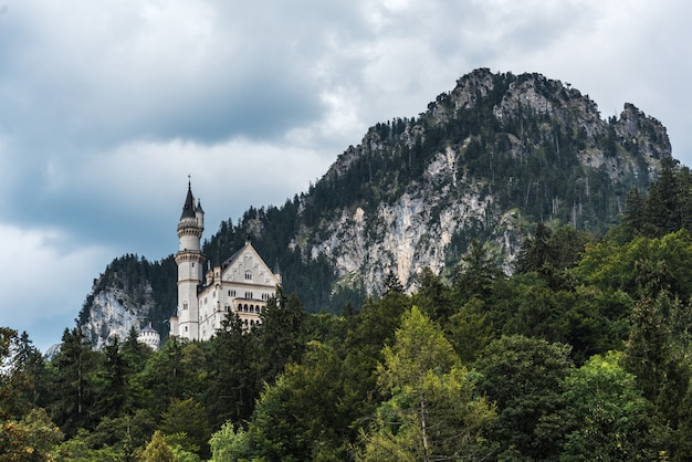 View from the village of Hohenschwangau on the Neuschwanstein castle. Behind the castle Bavarian alps