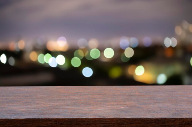 View from wooden plank above cityscape bokeh