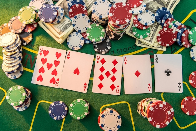 View of a gaming table with many poker card and chips green mat