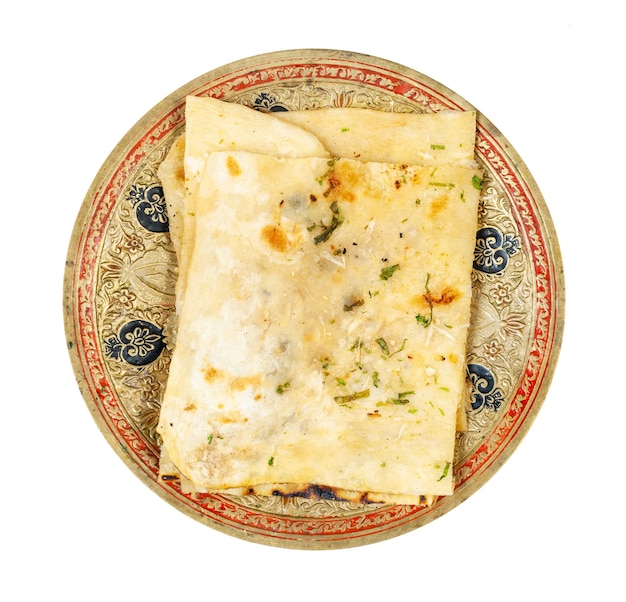 View of garlic naan flatbread on plate isolated