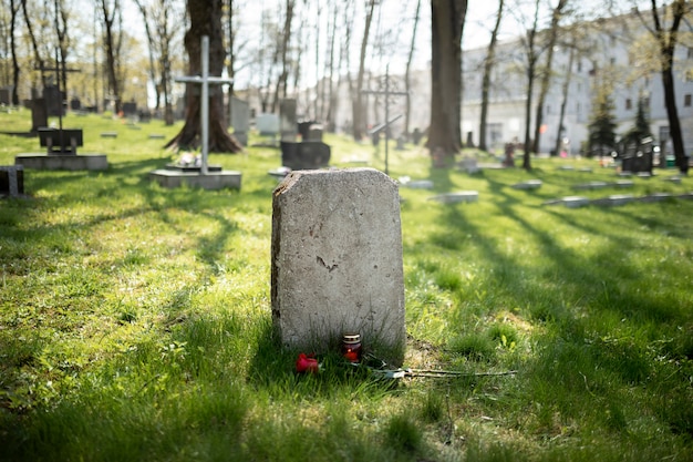 Photo view of gravestone with flowers and candle