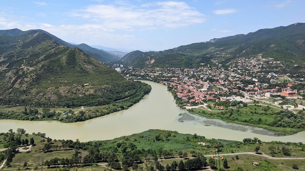 View of green mountains river and city