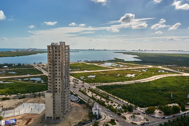 A view of the green valley with big houses and the sea in the distance