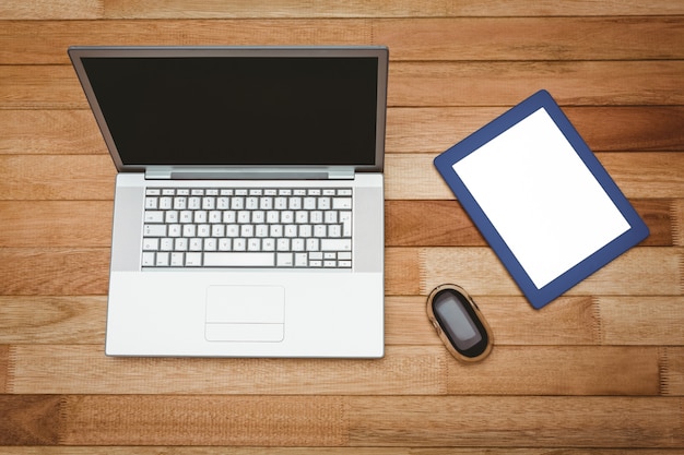 View of a grey laptop and a blue tablet