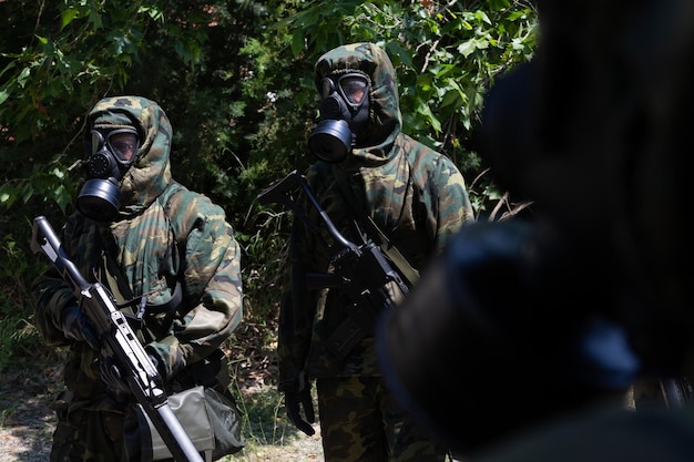 View of a group of soldiers with chemical protection suits and gas masks