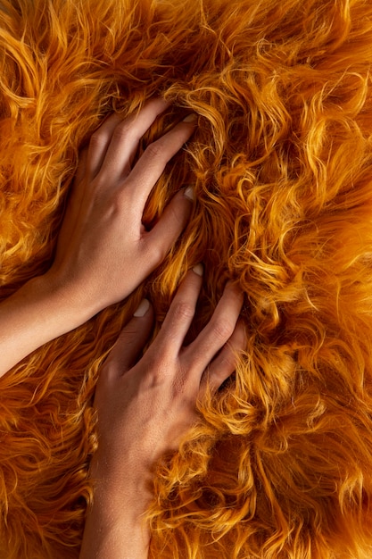 View of hand going through textured fur fabric