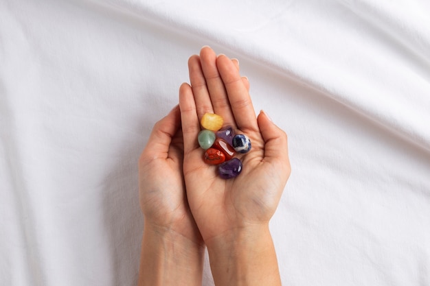 Photo above view hand wearing colorful crystals