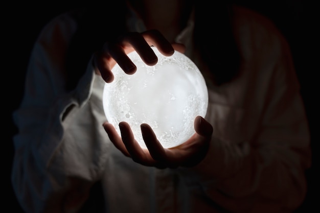 Photo view of hands holding moon light