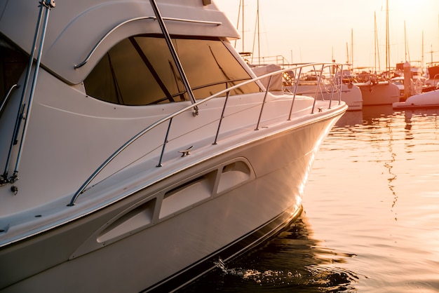 Photo view of harbor with yachts details. beautiful sunset sky in the marina bay.