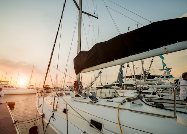 View of harbor with yachts details. Beautiful sunset sky in the marina bay.