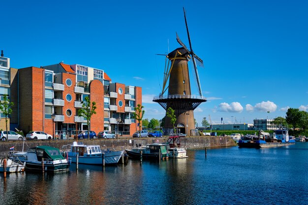 View of the harbour of delfshaven and the old grain mill de destilleerketel rotterdam netherlands