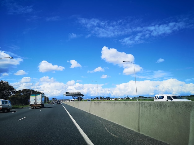 View of highway against blue sky