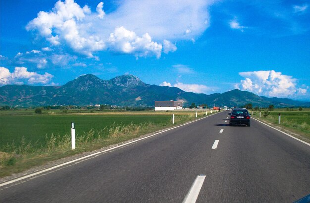 View of highway against cloudy sky