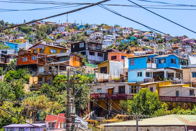 A view of a hill with houses and a hill in the background Valparaiso Chile