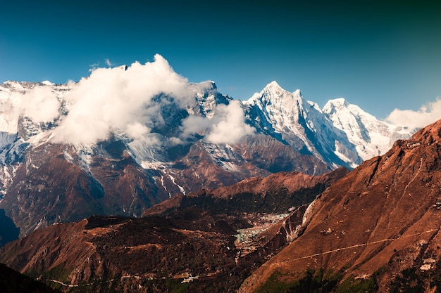 View of Himalaya mountains with clouds. Khumbu valley, Everest region, Nepal. Beautiful autumn landscape