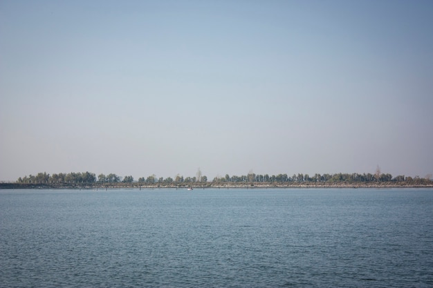 View of the horizon with vegetation at the bottom in the middle of the river Po in Italy.