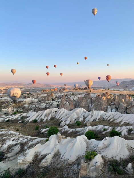 View of hot air balloons flying over rocks