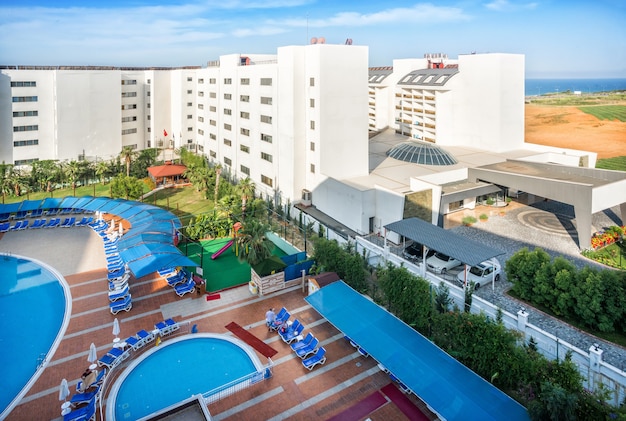 View of the hotel in Turkey from the balcony and blue pools and the Mediterranean Sea