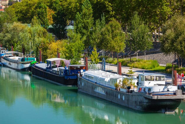 View of houseboats on the river in Lyon France Summer day shot