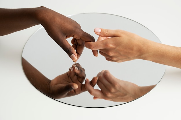 Photo view of human hands with mirror