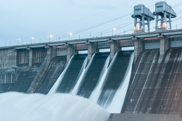 View of the hydroelectric power plant. Water discharge. Picture on long endurance.