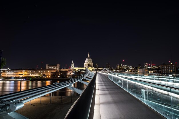 View of illuminated bridge and buildings at night