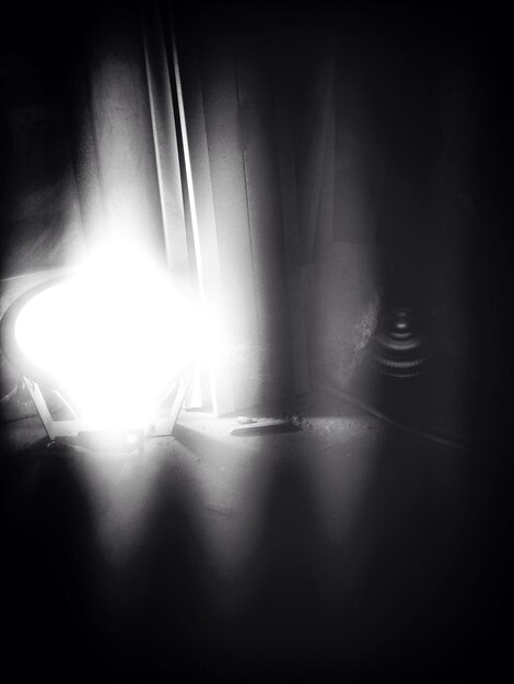 Photo view of illuminated lamp in dark room