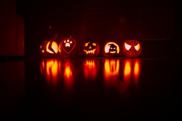 View of illuminated pumpkins against black background