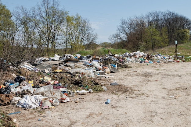 A view of the landfill garbage dump a pile of plastic rubbish\
food waste and other rubbish pollution concept a sea of garbage\
starts to invade and destroy a beautiful countryside scenery