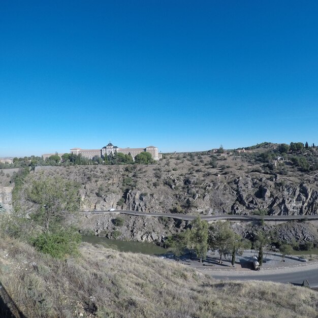 View of landscape against clear blue sky