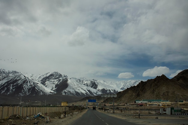 View landscape beside road with Indian people drive car on Srinagar Leh Ladakh highway go to view point of Confluence of the Indus and Zanskar River at Leh Ladakh in Jammu and Kashmir India in winter
