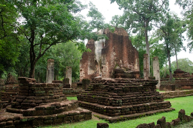 View landscape of buddha statue at Wat Phra Si Iriyabot in ancient building and ruins city of Kamphaeng Phet Historical Park is an archaeological site and Aranyik Area in Kamphaeng Phet Thailand