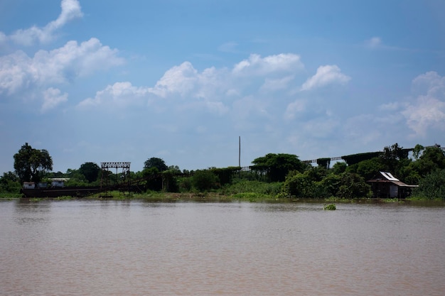 View landscape and chao phraya river with old house and antique\
retro vintage home at riverside pathumthani city and movement water\
while high north water and flood in pathum thani thailand