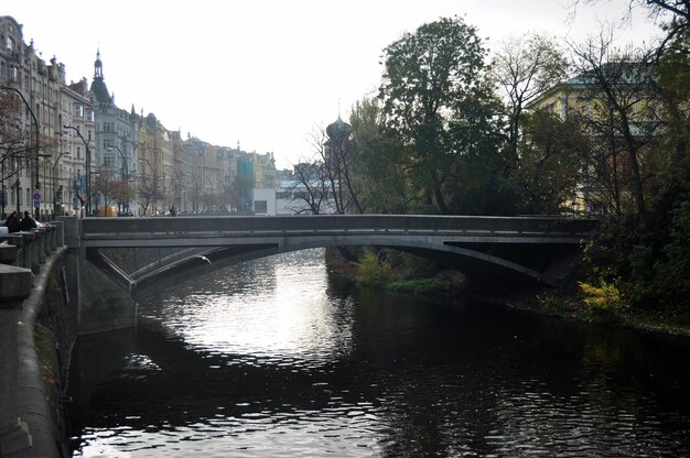 View landscape cityscape classic antique building for Czechia people and foreign traveler travel visit walking on small bridge crossing canal in winter at Praha old town city in Prague Czech Republic