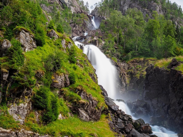 View on Langfossen waterfall in summer Etne Norway