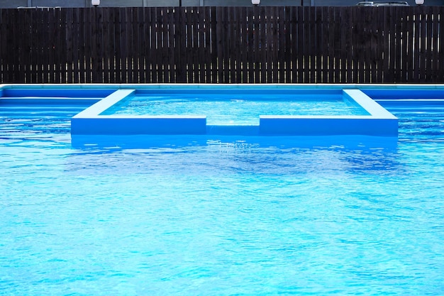 View of the large swimming pool on a sunny day closeup