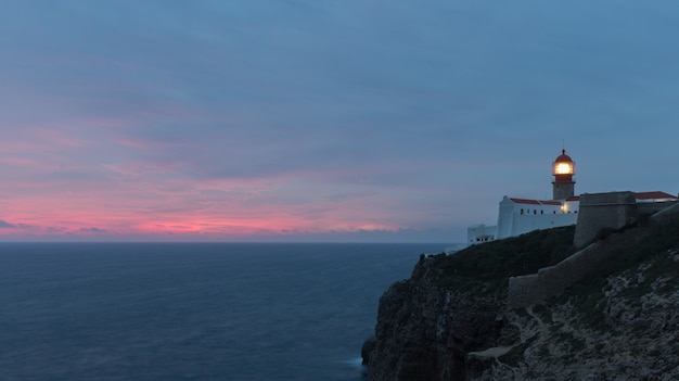 View of the lighthouse and cliffs at Cape St. Vincent at sunset. Continental Europe's most South-western point, Sagres, Algarve, Portugal.