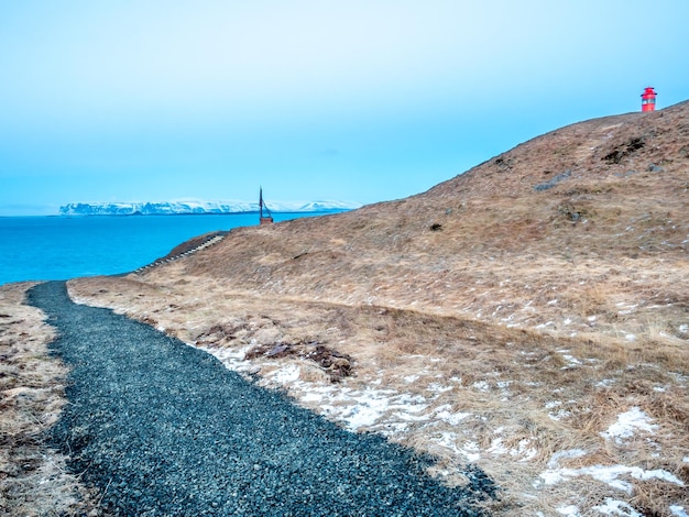 View on lighthouse hill of Stykkisholmur town under twilight evening sky in Iceland