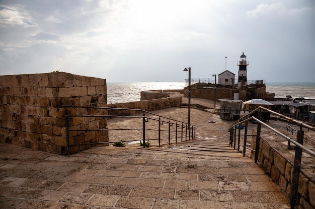 View of the Lighthouse on the Mediterranean Sea during a sunny and cloudy day