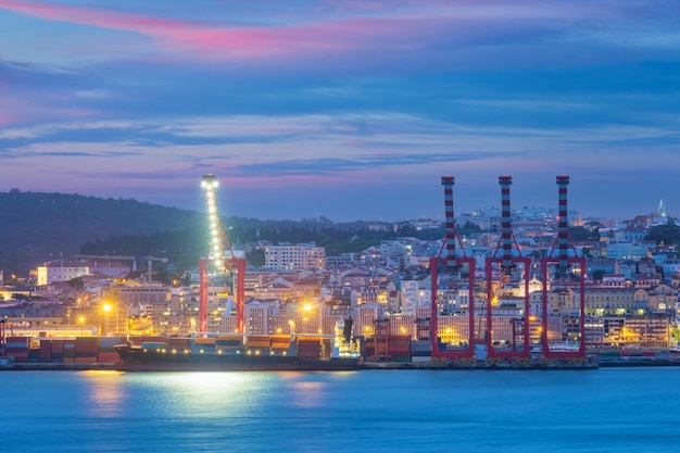 View of Lisbon port with moored sea container ship with cranes in the evening Lisbon Portugal