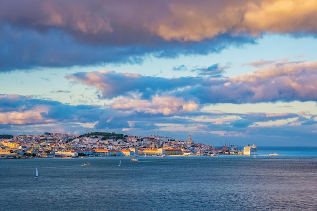 리스본 포르투갈(Lisbon Portugal) 일몰에 관광 보트와 정박된 크루즈 라이너가 있는 타구스 강(Tagus River) 너머의 리스본(Lisbon) 전망