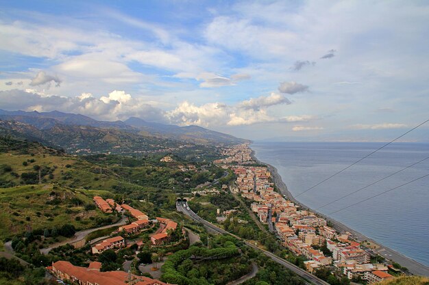 View of the long coast buildings close to the beach ionian sea hilly and hills sicily taormina